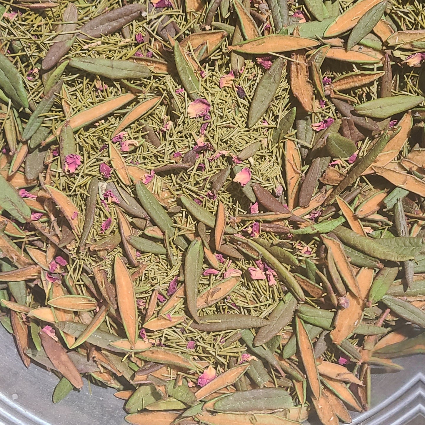 Dry herbs or leaves on a metal tray